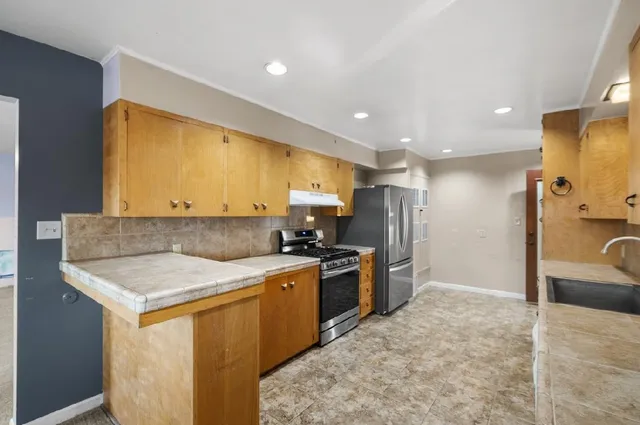 a kitchen with a stove and a refrigerator