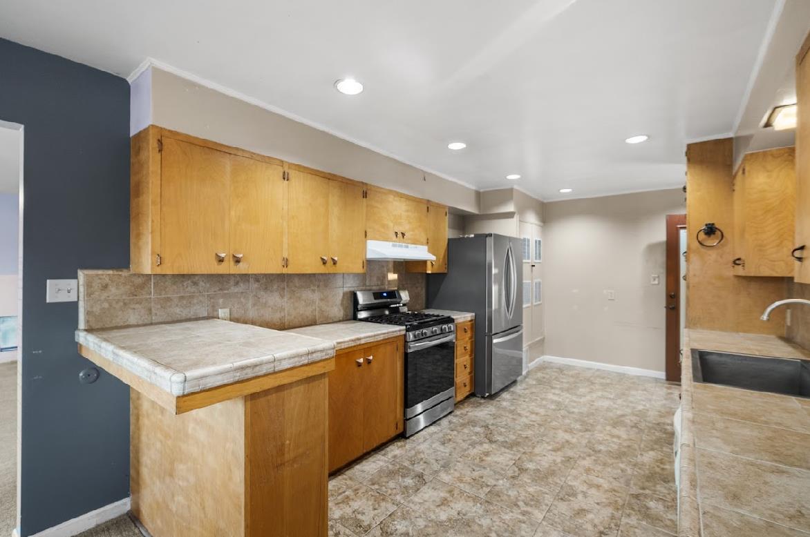 3402 Burson Road Burson, CA 95225 - Photo 15 of 65 a kitchen with a sink stove and refrigerator
