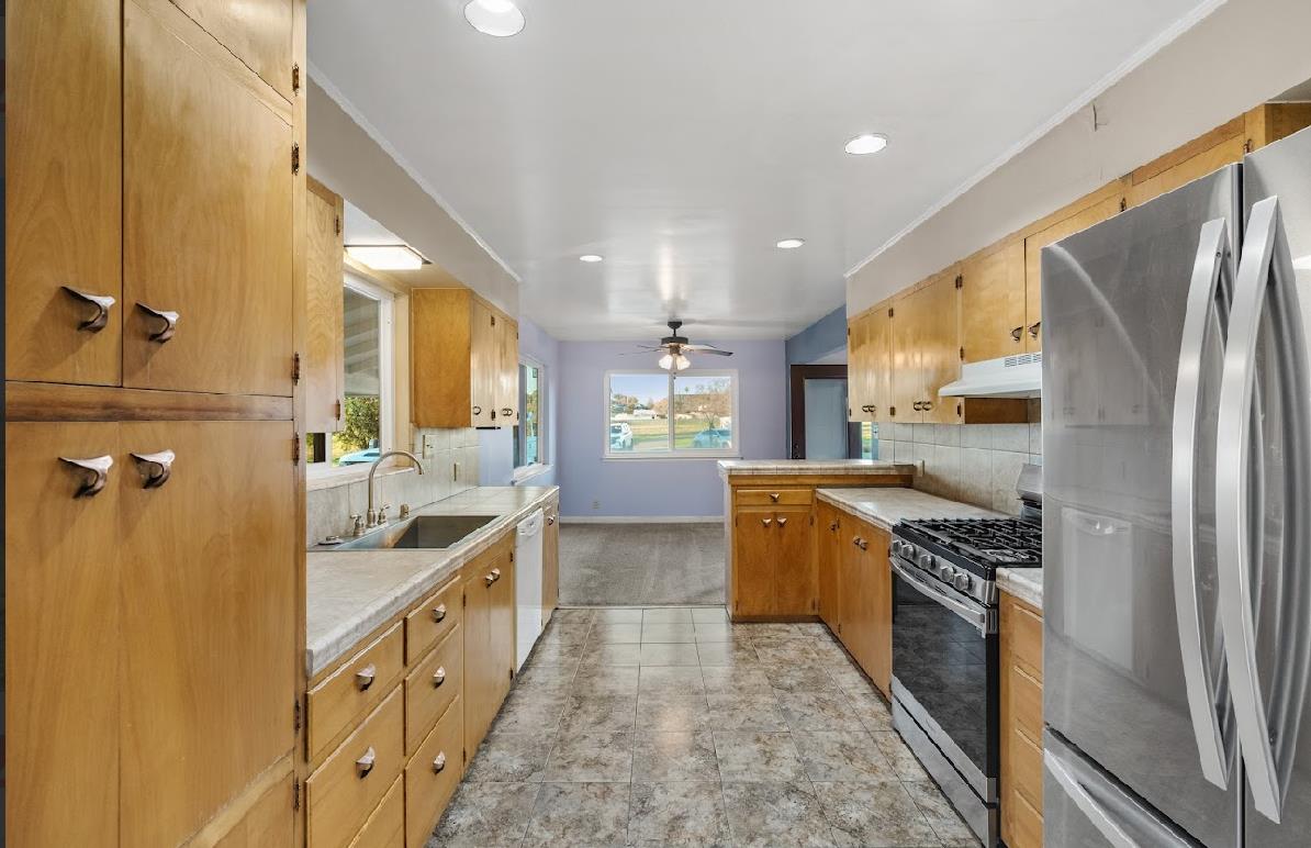 3402 Burson Road Burson, CA 95225 - Photo 16 of 65 a kitchen with stainless steel appliances granite countertop a refrigerator a stove and a sink