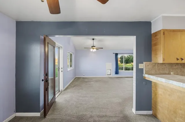 a view of hallway with a floor to ceiling window and wooden floor