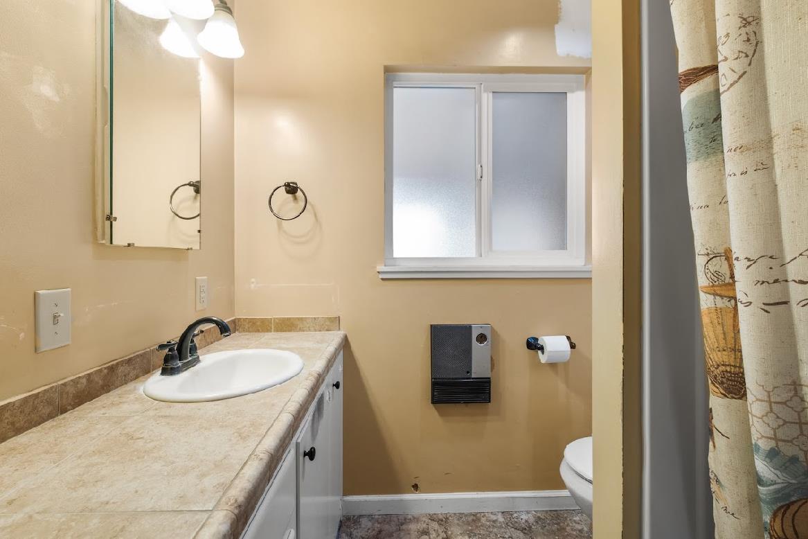3402 Burson Road Burson, CA 95225 - Photo 26 of 65 a bathroom with a sink vanity granite and a mirror