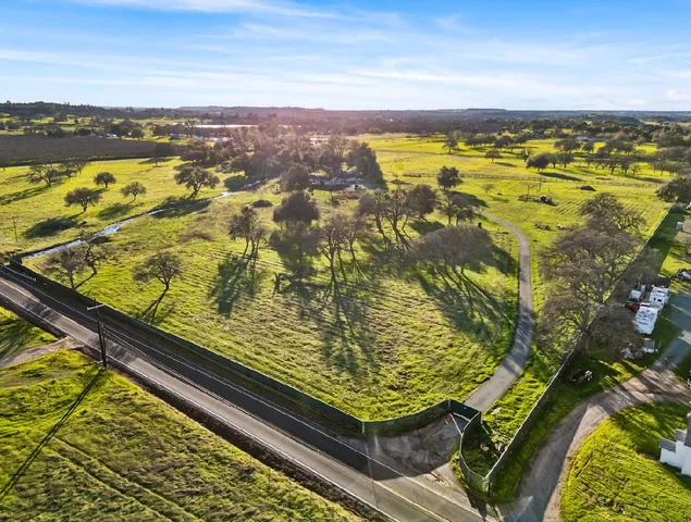 an aerial view of a house with yard swimming pool and outdoor seating