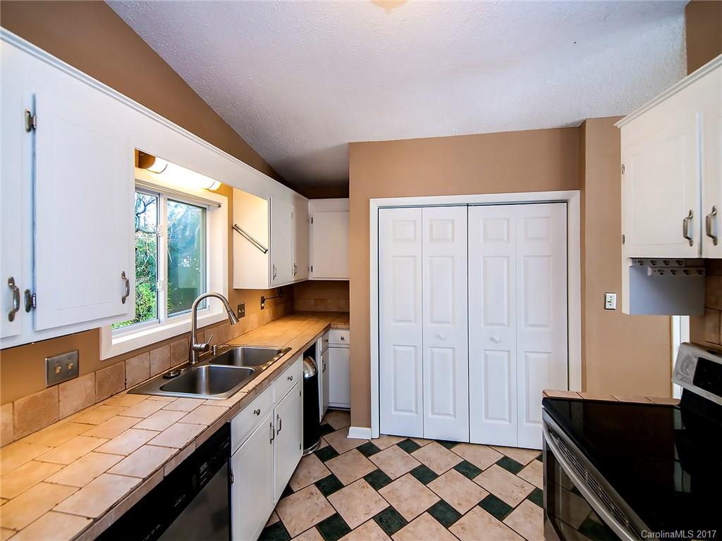 9009 Cebu Court, Unit 9 Tega Cay, SC 29708 - Photo 11 of 24 a kitchen with a sink a stove a refrigerator and cabinets