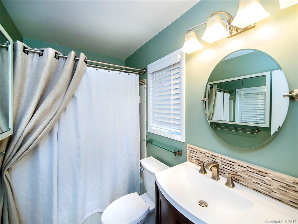 9009 Cebu Court, Unit 9 Tega Cay, SC 29708 - Photo 12 of 24 a bathroom with a sink mirror and toilet