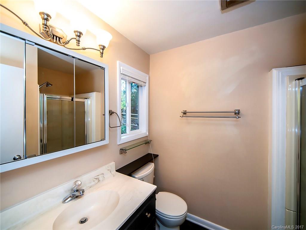 9009 Cebu Court, Unit 9 Tega Cay, SC 29708 - Photo 15 of 24 a bathroom with a sink a toilet and shower