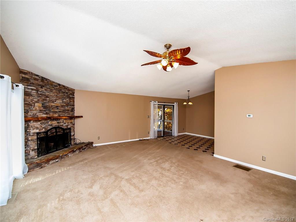 9009 Cebu Court, Unit 9 Tega Cay, SC 29708 - Photo 4 of 24 an empty room with windows and ceiling fan