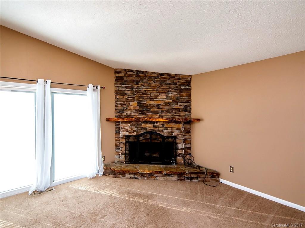 9009 Cebu Court, Unit 9 Tega Cay, SC 29708 - Photo 5 of 24 a living room with a fireplace