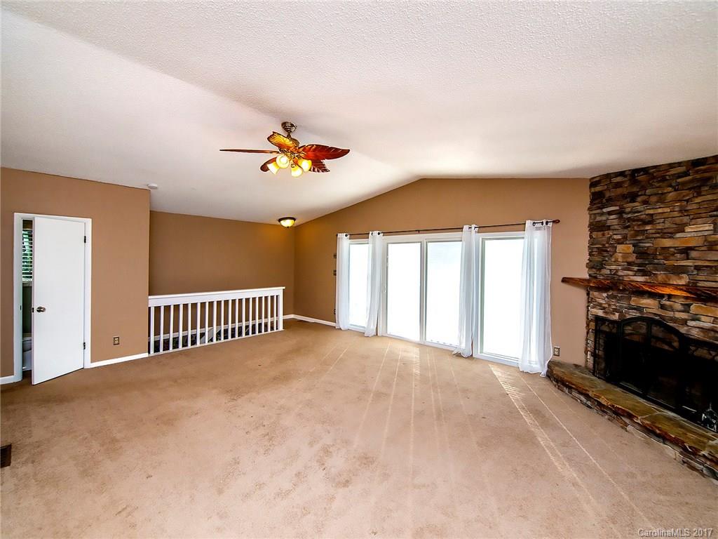 9009 Cebu Court, Unit 9 Tega Cay, SC 29708 - Photo 6 of 24 a view of a livingroom with a staircase