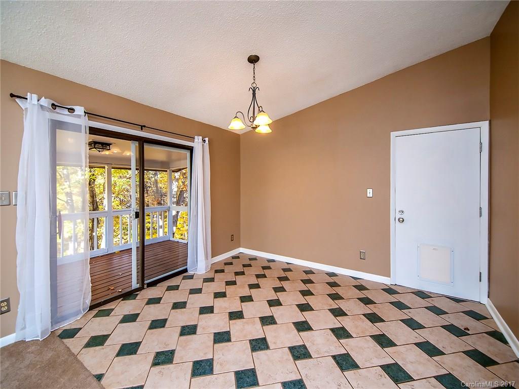 9009 Cebu Court, Unit 9 Tega Cay, SC 29708 - Photo 7 of 24 a bedroom with a bed and a lamp on a dresser