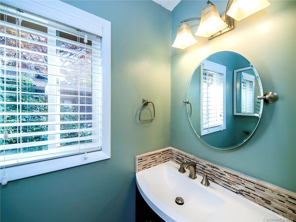 9009 Cebu Court, Unit 9 Tega Cay, SC 29708 - Photo 8 of 24 a bathroom with a sink a mirror and window