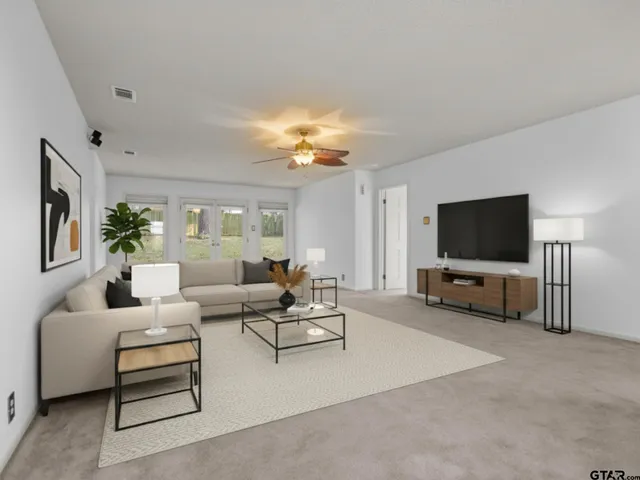 a living room with furniture and a flat screen tv