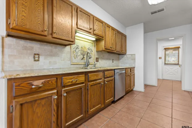 a kitchen with stainless steel appliances granite countertop a sink and cabinets