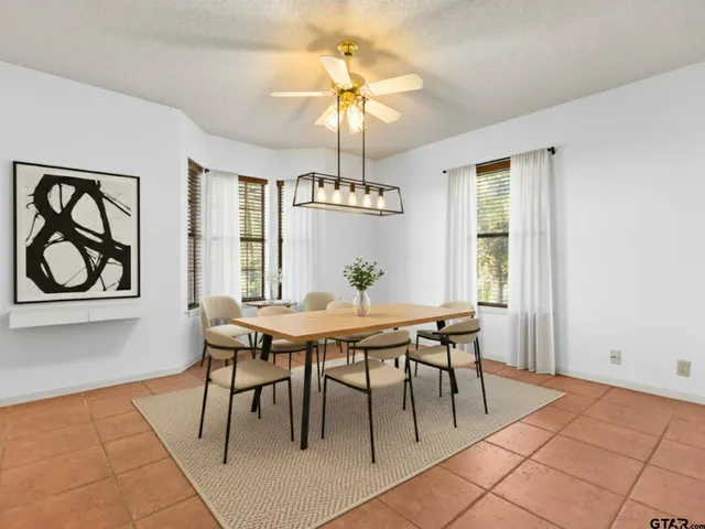 a view of a dining room with furniture and window