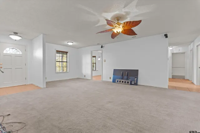 a view of an empty room with window and cabinet