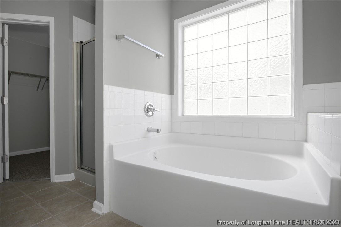 92 Holly Oak Circle Bunnlevel, NC 28323 - Photo 14 of 23 a white bath tub sitting next to a window