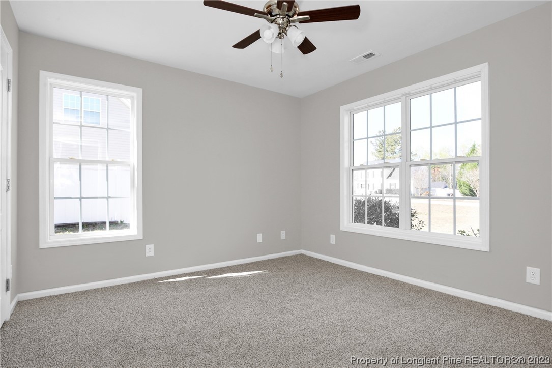 92 Holly Oak Circle Bunnlevel, NC 28323 - Photo 16 of 23 an empty room with a window and a ceiling fan