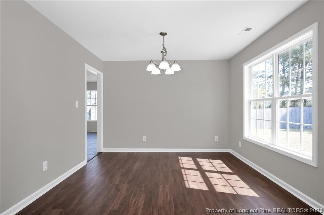 92 Holly Oak Circle Bunnlevel, NC 28323 - Photo 6 of 23 wooden floor in an empty room with a window