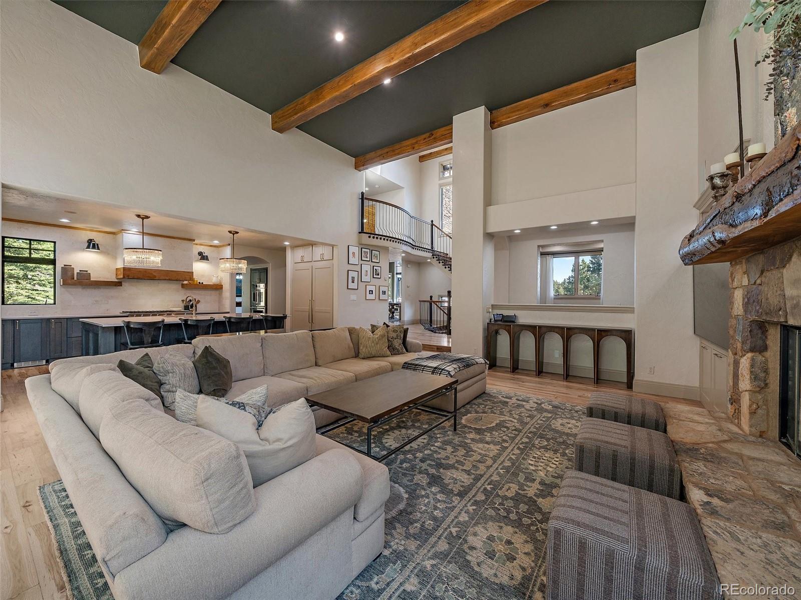 33442 Meadow Mountain Road Evergreen, CO 80439 - Photo 11 of 40 a living room with furniture and a fireplace
