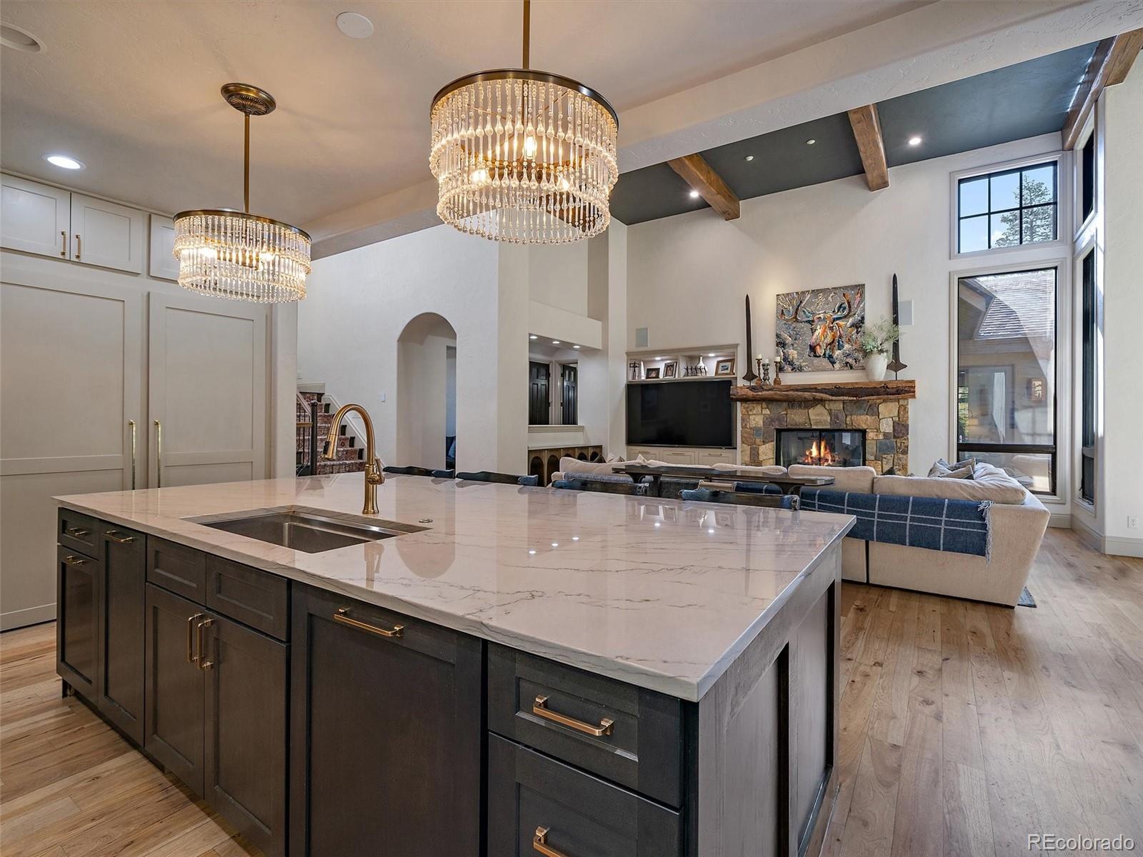 33442 Meadow Mountain Road Evergreen, CO 80439 - Photo 14 of 40 a large kitchen with sink a refrigerator and chairs