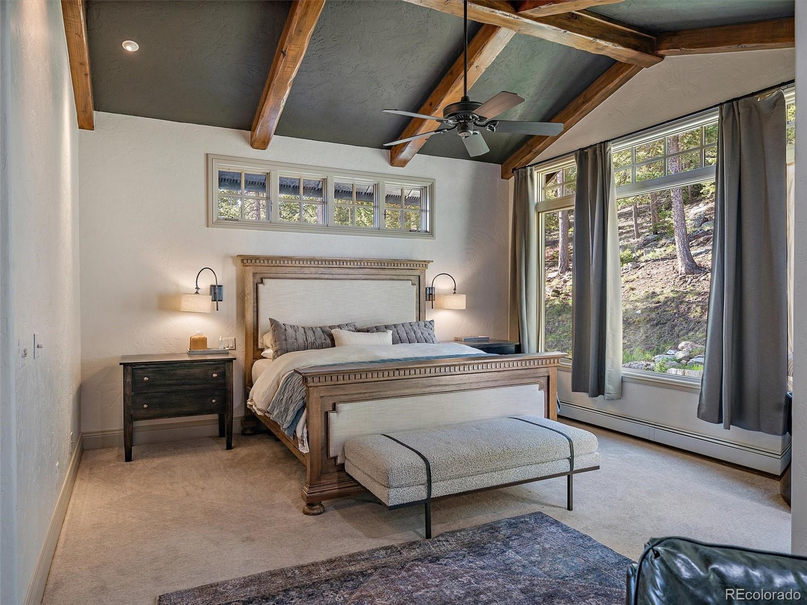 33442 Meadow Mountain Road Evergreen, CO 80439 - Photo 16 of 40 a bedroom with a bed and a large window