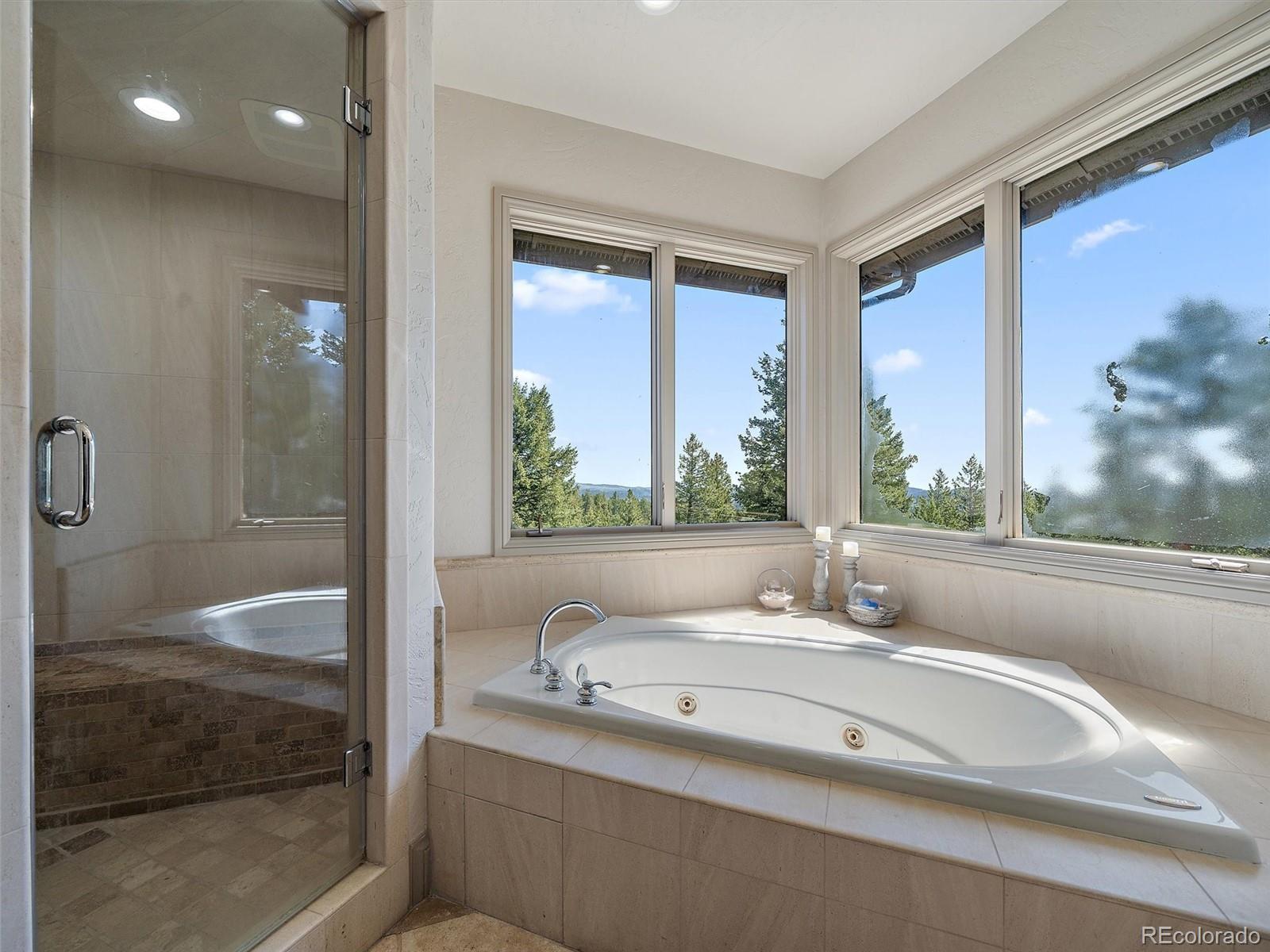 33442 Meadow Mountain Road Evergreen, CO 80439 - Photo 19 of 40 a bathroom with a granite countertop sink and a large mirror