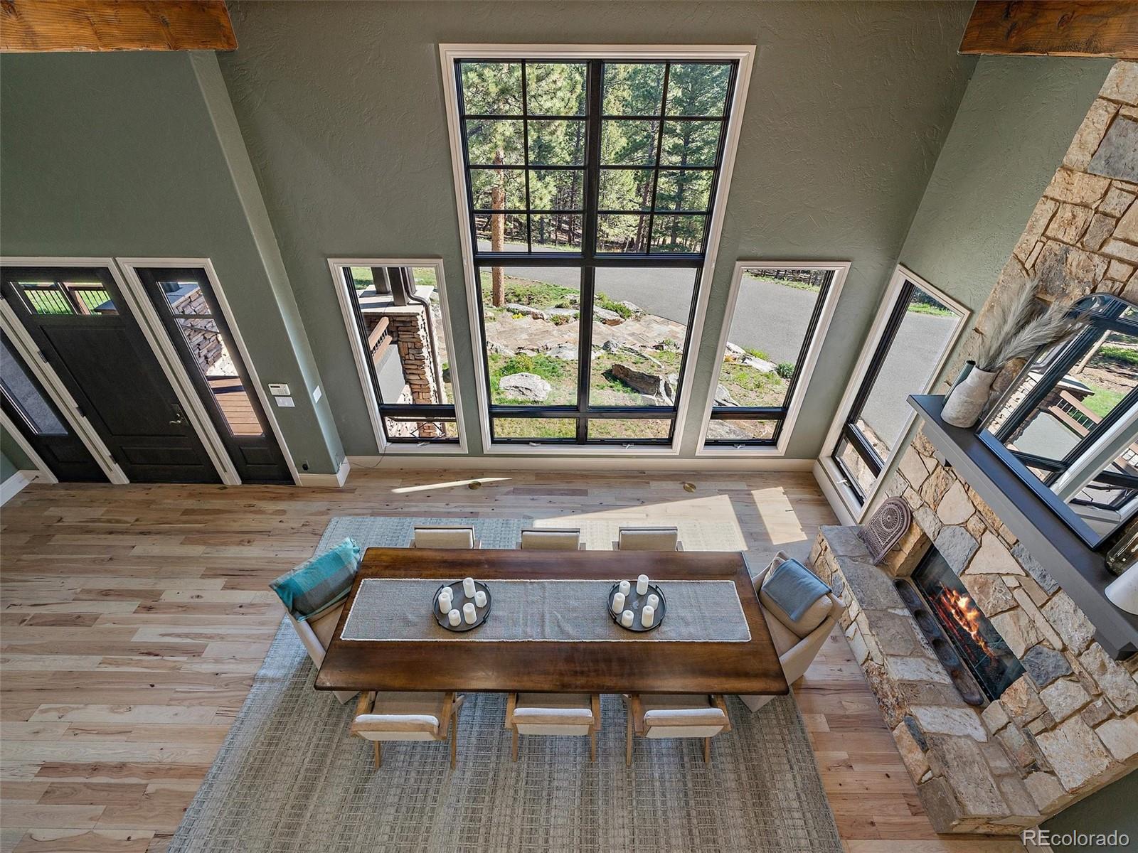 33442 Meadow Mountain Road Evergreen, CO 80439 - Photo 24 of 40 a living room with furniture and a fireplace