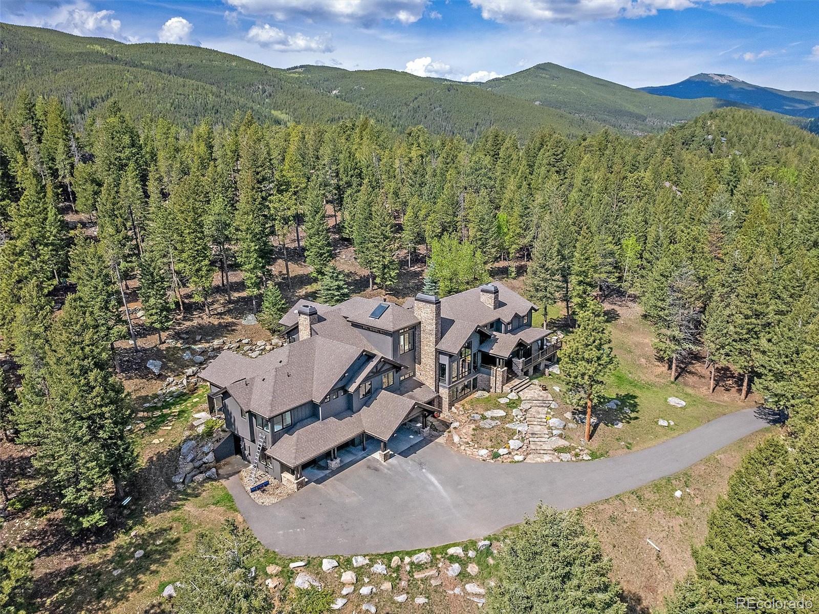 33442 Meadow Mountain Road Evergreen, CO 80439 - Photo 3 of 40 an aerial view of a house with a yard