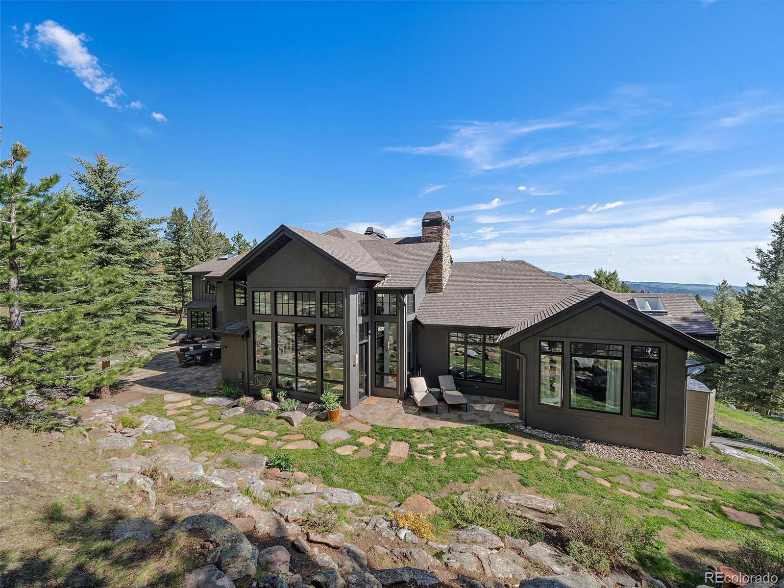 33442 Meadow Mountain Road Evergreen, CO 80439 - Photo 34 of 40 a front view of a house with a yard