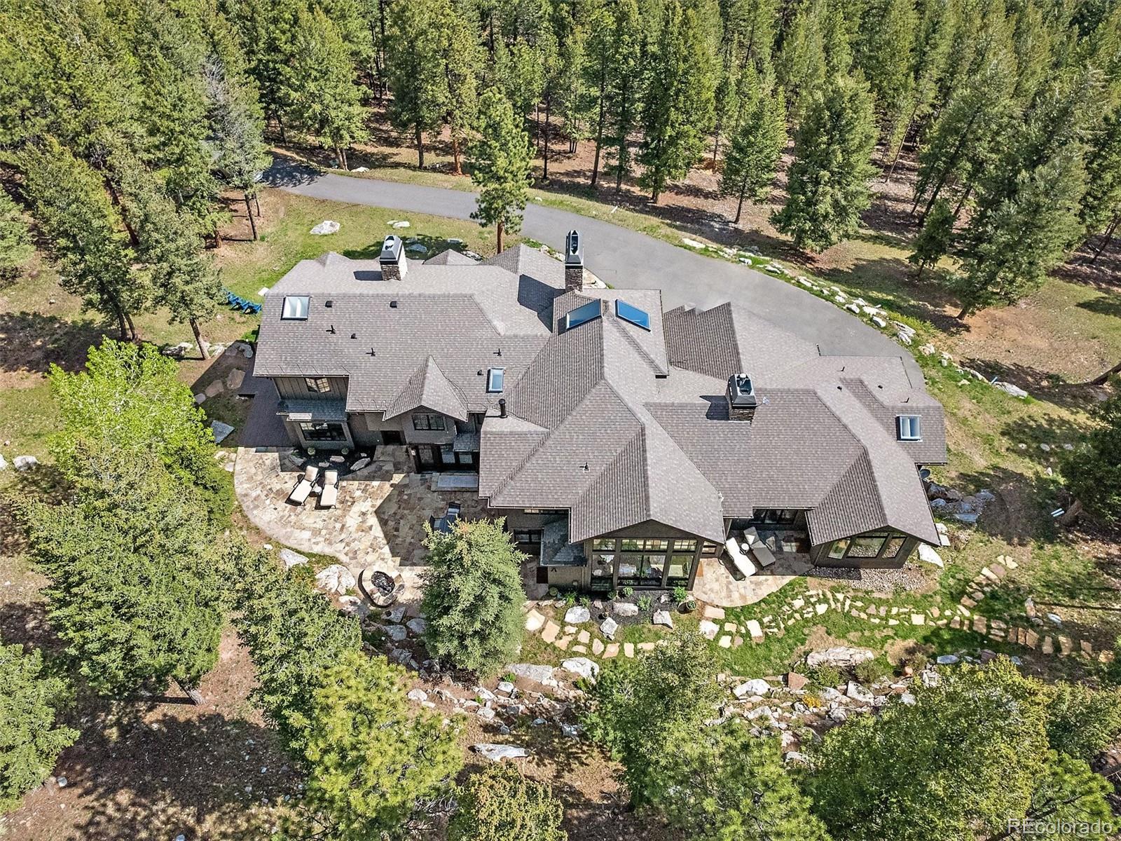 33442 Meadow Mountain Road Evergreen, CO 80439 - Photo 37 of 40 an aerial view of residential house with outdoor space and trees all around