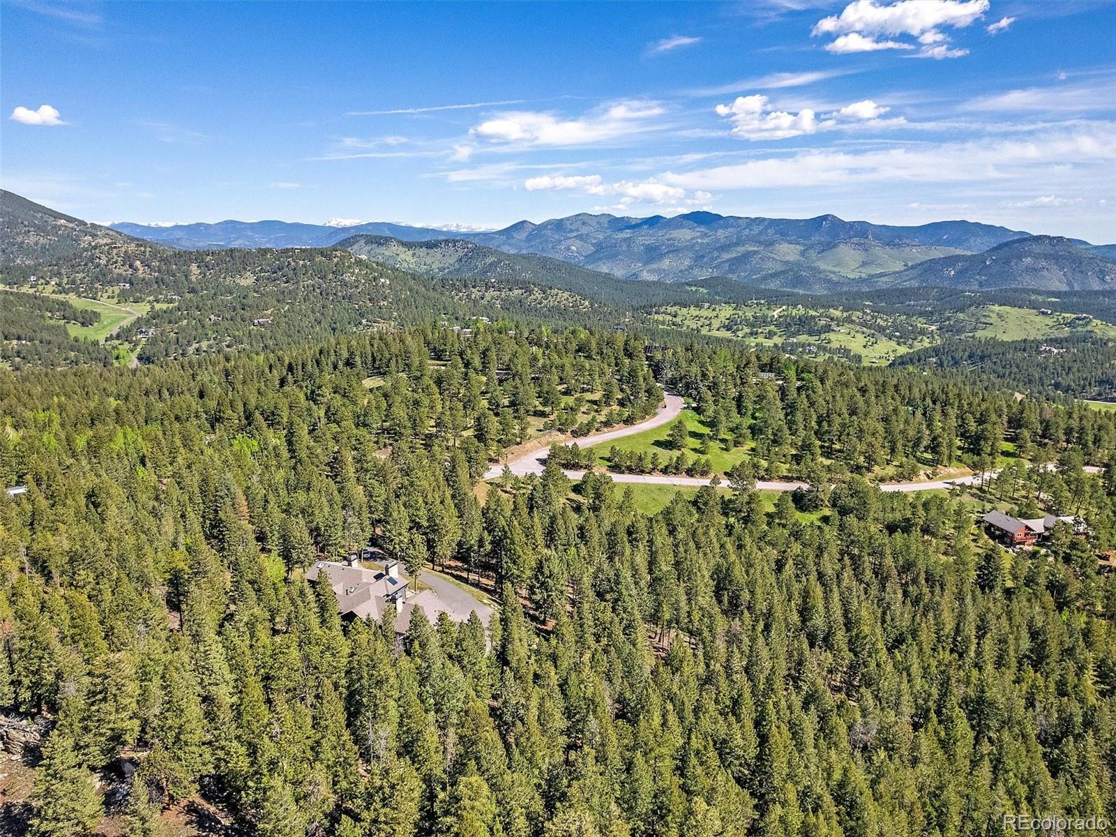33442 Meadow Mountain Road Evergreen, CO 80439 - Photo 38 of 40 a view of a town with mountains in the background