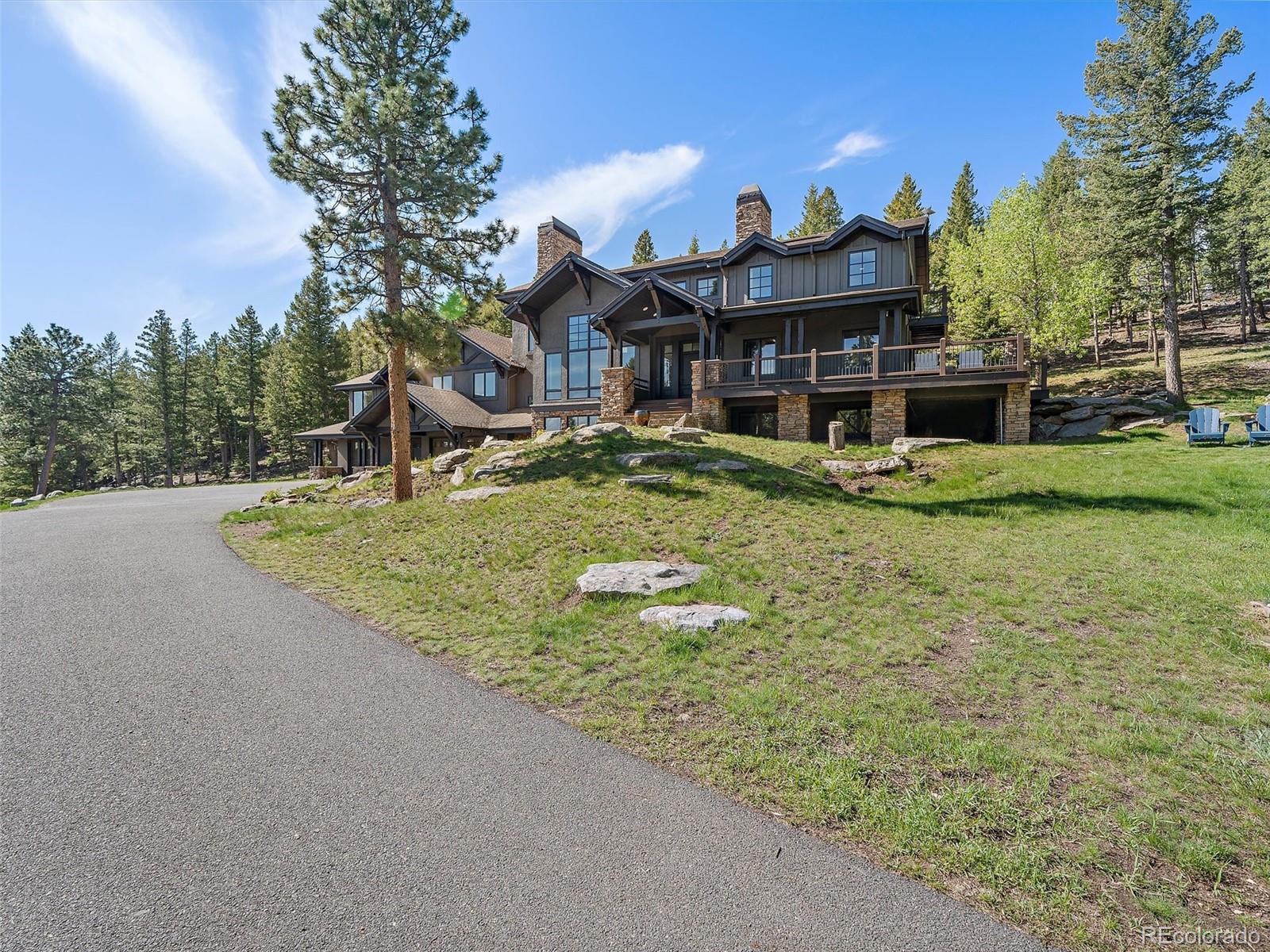 33442 Meadow Mountain Road Evergreen, CO 80439 - Photo 40 of 40 a front view of a house with garden
