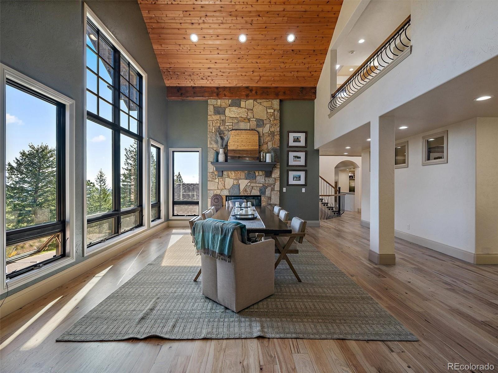 33442 Meadow Mountain Road Evergreen, CO 80439 - Photo 5 of 40 a living room with furniture a rug and a large window