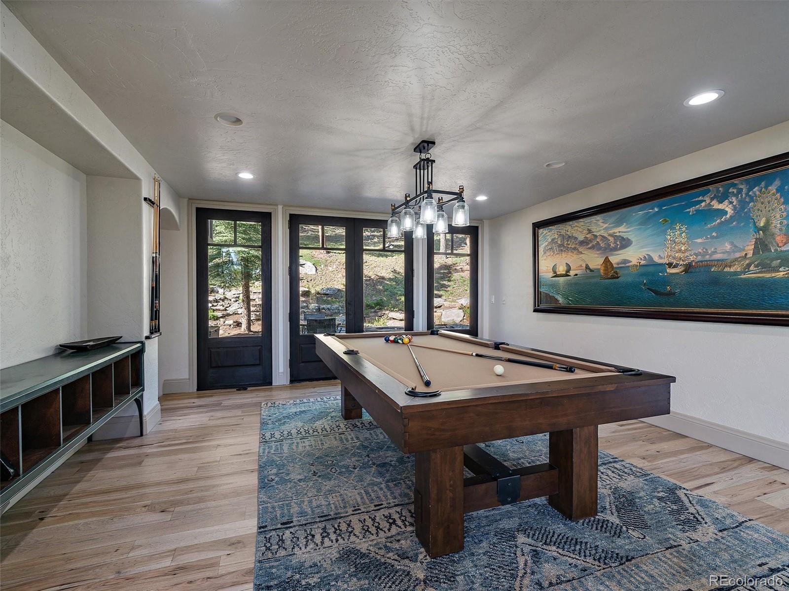 33442 Meadow Mountain Road Evergreen, CO 80439 - Photo 7 of 40 a room with pool table and windows