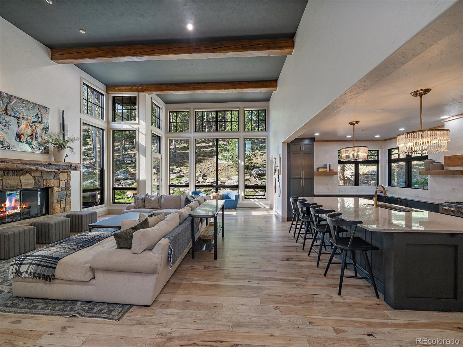 33442 Meadow Mountain Road Evergreen, CO 80439 - Photo 8 of 40 a living room with furniture and a fireplace