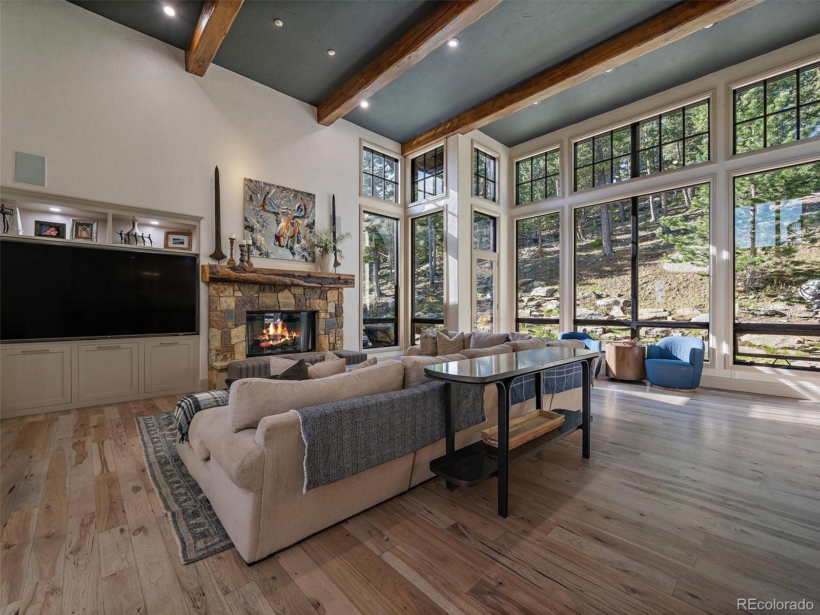 33442 Meadow Mountain Road Evergreen, CO 80439 - Photo 9 of 40 a living room with furniture and a fireplace