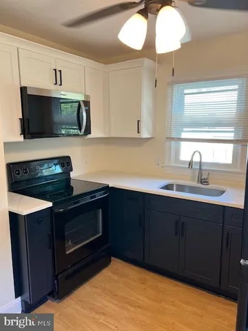 a kitchen with stainless steel appliances a stove a sink and a microwave