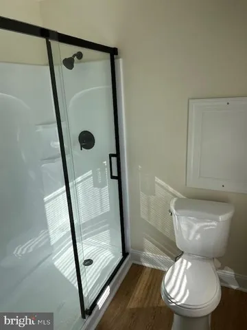 a bathroom with a toilet and a shower