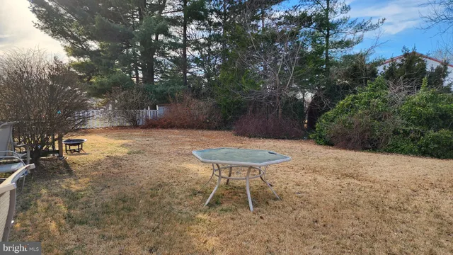 a view of a backyard with a table and chairs