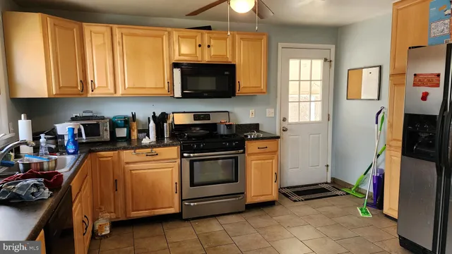 a kitchen with stainless steel appliances granite countertop a stove and a microwave