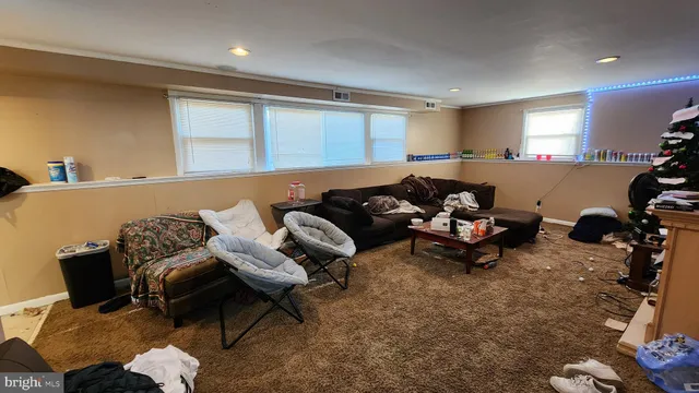 a living room with furniture a couch and a window