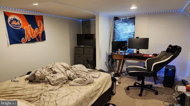 a bedroom with a bed and a desk