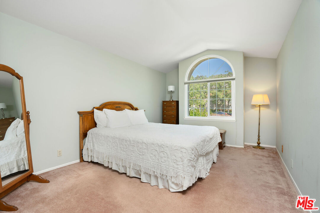 22211 Frontier Place Chatsworth, CA 91311 - Photo 12 of 26 a bedroom with a bed and a window