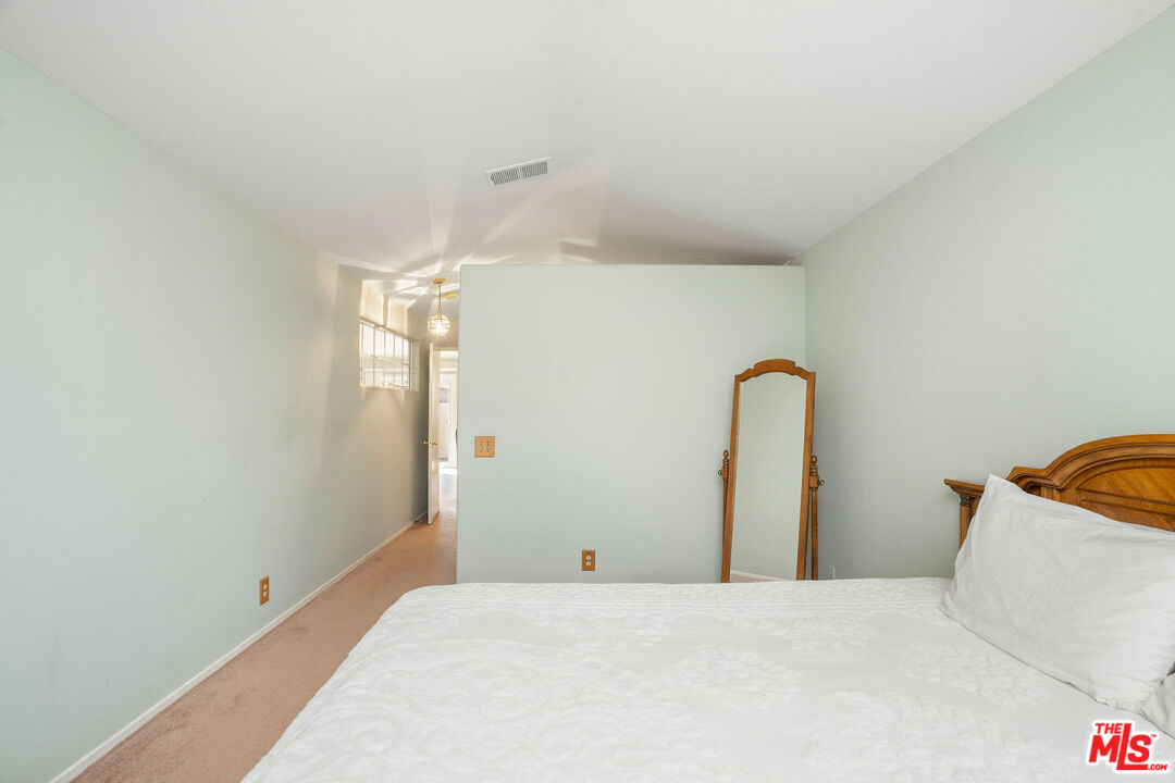 22211 Frontier Place Chatsworth, CA 91311 - Photo 14 of 26 a bedroom with a bed and a table