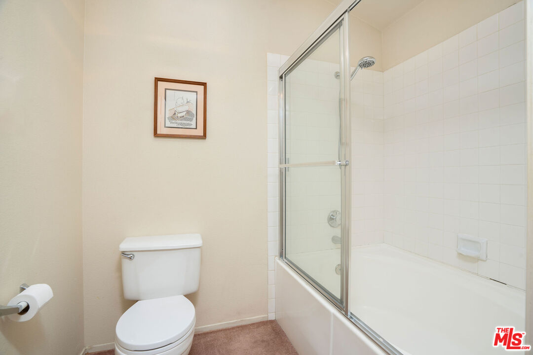 22211 Frontier Place Chatsworth, CA 91311 - Photo 16 of 26 a white toilet sitting next to a bath tub