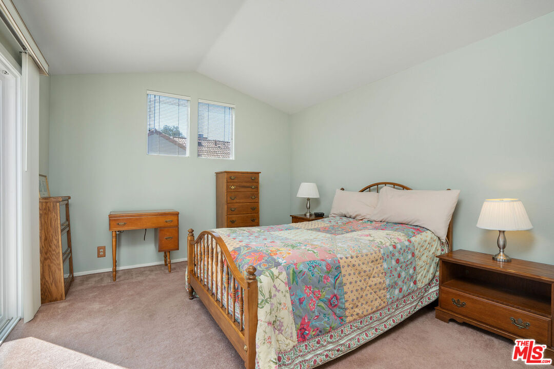 22211 Frontier Place Chatsworth, CA 91311 - Photo 17 of 26 a bedroom with a bed and a lamp