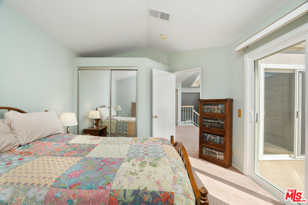 22211 Frontier Place Chatsworth, CA 91311 - Photo 18 of 26 a bedroom with a bed and a large mirror