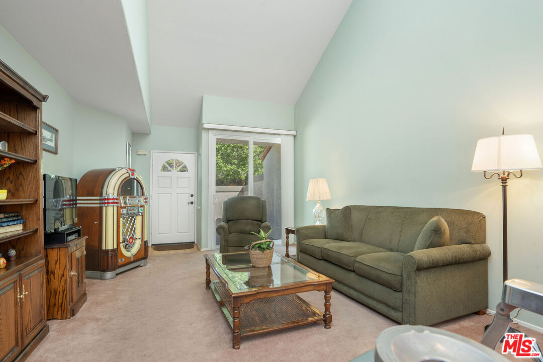 22211 Frontier Place Chatsworth, CA 91311 - Photo 4 of 26 a living room with furniture and a flat screen tv