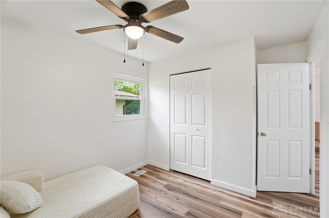 1923 Portage Path Springfield, OH 45506 - Photo 26 of 40 A well-lit bedroom features durable laminate flooring and a ceiling fan for year-round comfort.