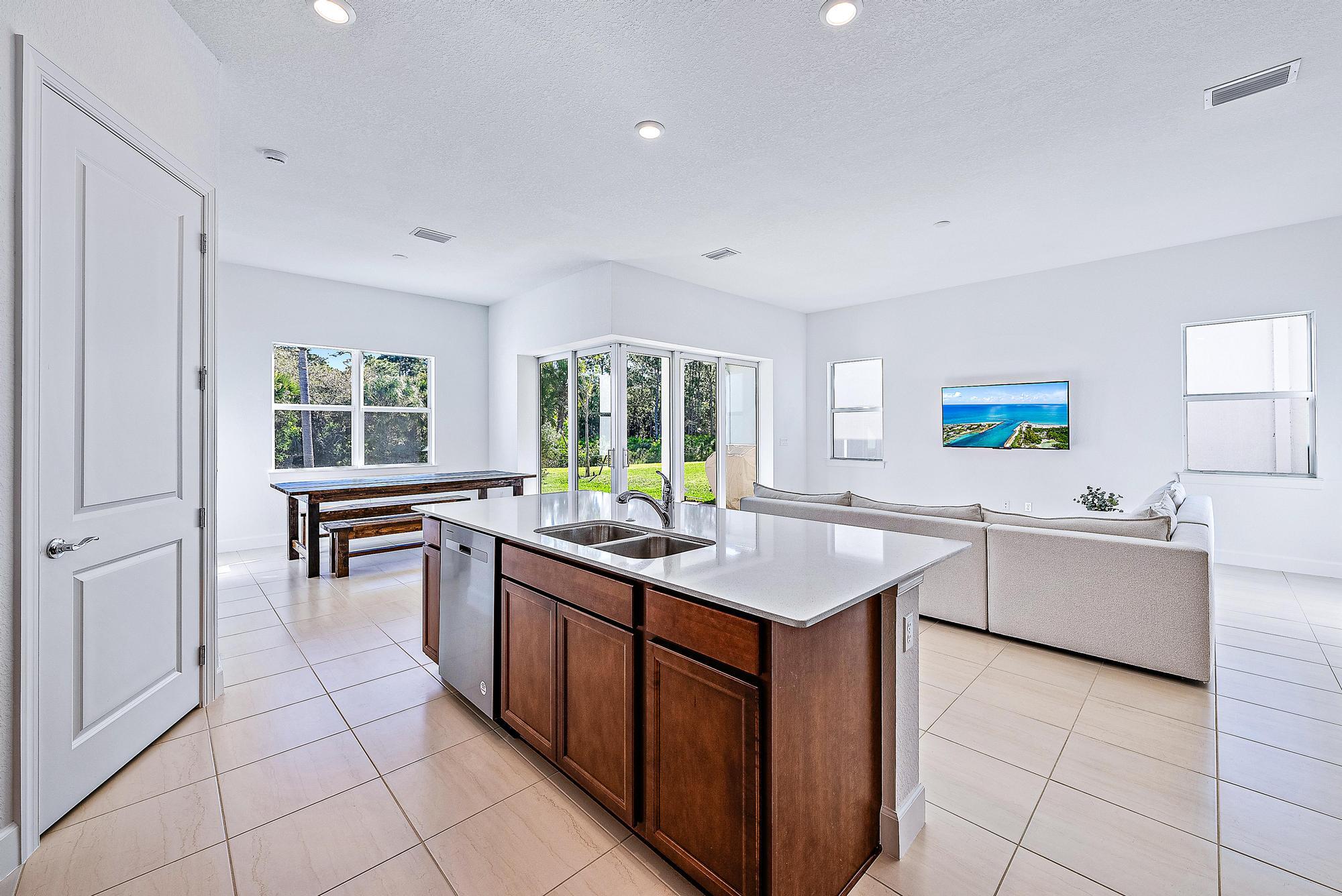 9775 Southwest Meridian Way Stuart, FL 34997 - Photo 3 of 33 Kitchen island overlooking living area