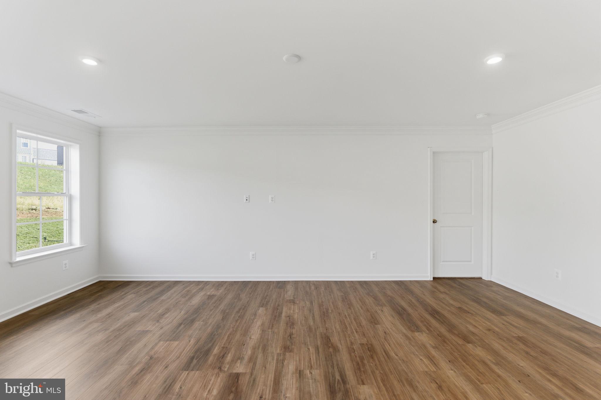 205 Pheasant Ridge Road Hanover, PA 17331 - Photo 12 of 27 an empty room with wooden floor and windows